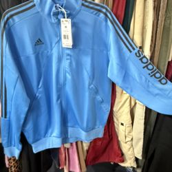 The jacket is a Men's Adidas Tiro 23 Wordmark Jacket in the color scheme "Semi Blue/black Size M New 