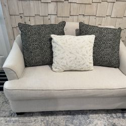 Cream Loveseat, Pillows Included.