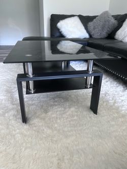 Leather sofa, fluffy carpet and glass coffee table