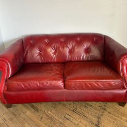 Delivery available red leather loveseat