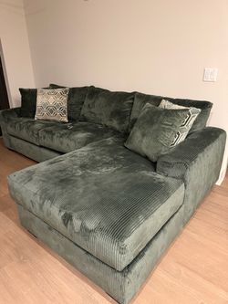 Green Corduroy Sectional Sofa with Chaise, pillows included.