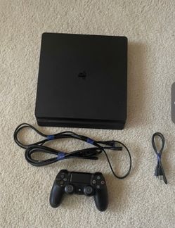 PS4 with video games and controller
