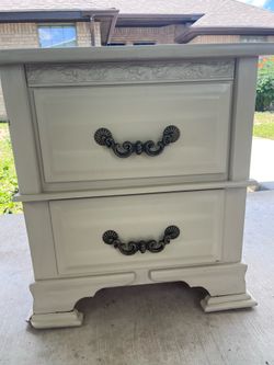 Beige nightstand with two drawers.