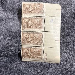 This is a plate block of four 4-cent U.S. postage stamps commemorating the Lincoln-Douglas Debates of 1858.
