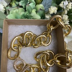 Gold tone choker necklace.