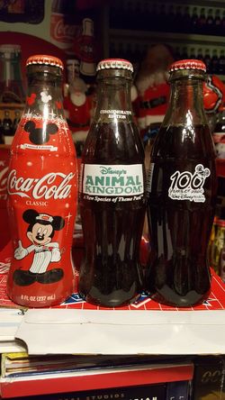 3 different Disney coke bottles