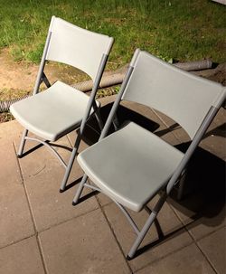 Two Gray Folding Chairs