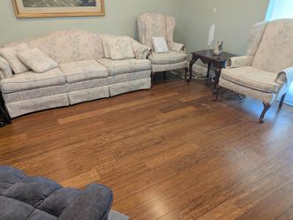 A couch, two chairs, and a big rug