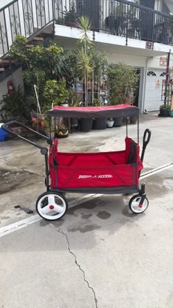 RADIO FLYER WAGON  seats two with safety  belts  2cup holders  adjustable canopy