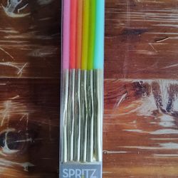 12-count pack of tall Colorful Birthday Cake Candles with Gold Dip.