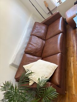 Brown leather sofa and matching ottoman
