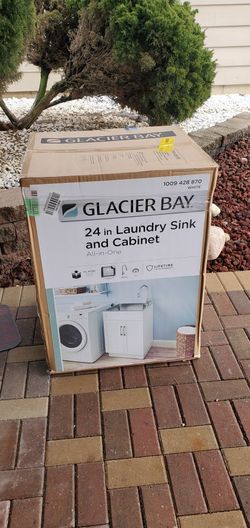 never used Glacier Bay 24 inch laundry sink and cabinet with faucet