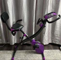Fitquest Exercise bike with resistance bands in the color purple/black.  Closes up for small spaces.