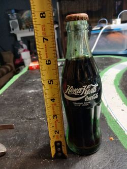 unopened 6.5 oz Coca-Cola bottle from the 1990 "Around the World