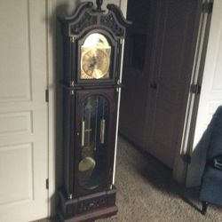 GRANDFATHER CLOCK MAROON IN COLOR….72X18X9 BATTERY OPERATED IN EXCELLENT CONDITION..RETAILS NEW AT 299.95 PUS TAX