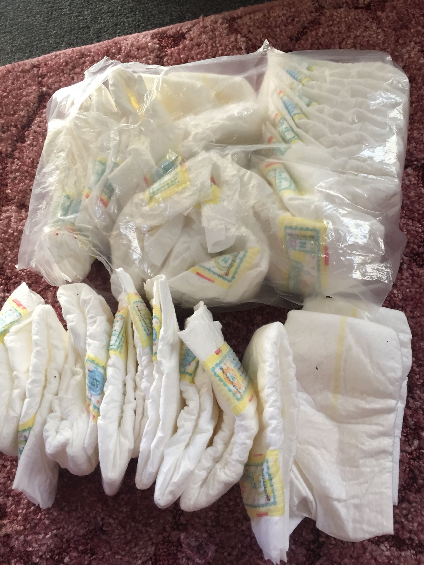 Newborn size diapers. Almost a full bag