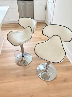 2 white spin chairs