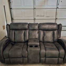 Signature Design by Ashley Turbulance Power Reclining Loveseat with Console and Adjustable Headrest 