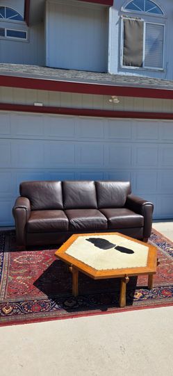 Rug, leather sofa, cow coffee table