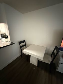 White Dining Table with 2 Black Chairs