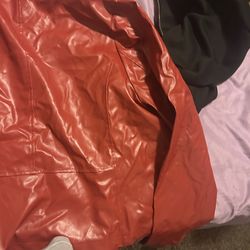 A red faux leather or polyurethane jacket