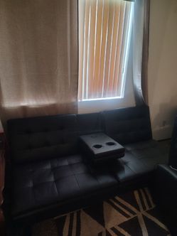 Leather couch with cupholder and phone charger adapter