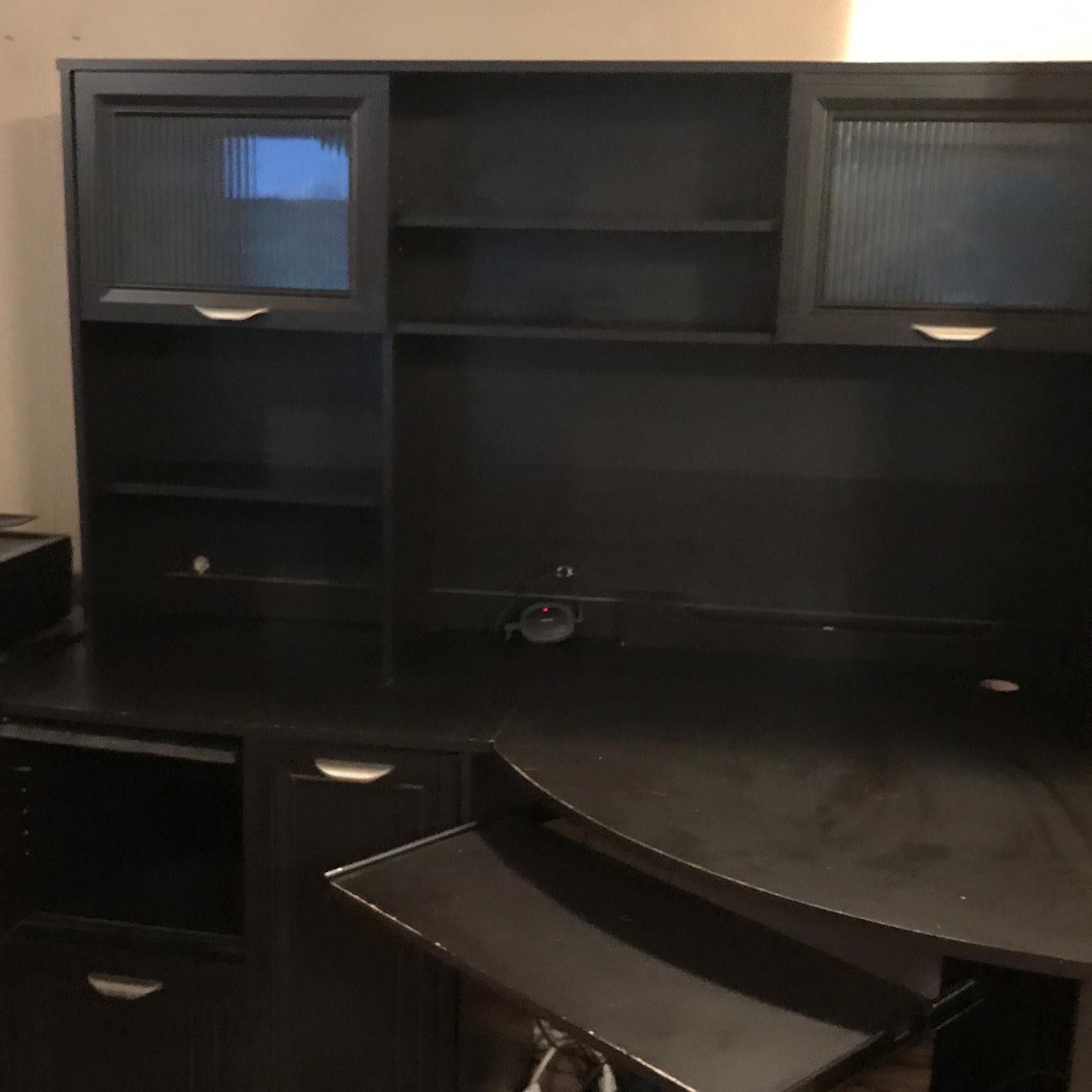 Corner desk with upper shelves and storage.
