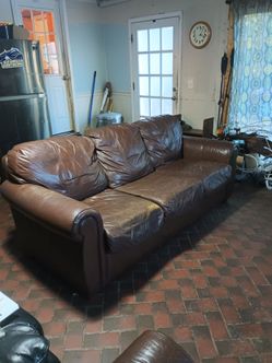 Brown leather couch and loveseat