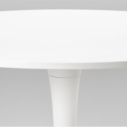 Four IKEA chairs with an IKEA round table + large waves painting