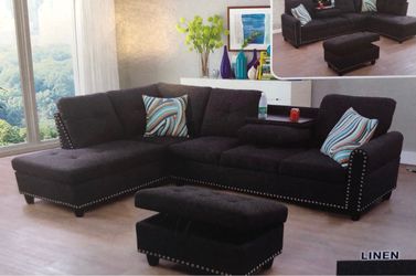 Charcoal black linen sectional couch and ottoman.