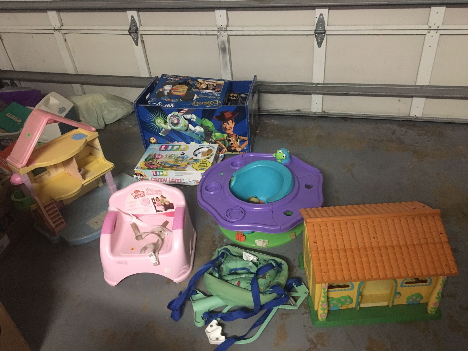 2 dollhouses, baby jumper, booster chair, bumbo chair with activity tray,toy box with games and stuffed animals