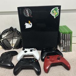 Xbox One with games, controller, and headset.