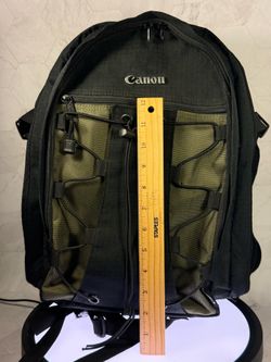 (1) Canon 200EG Deluxe Backpack for camera gear. It features a distinctive black and olive green color scheme. The backpack is designed to hold one to