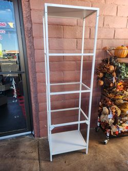 shelving unit in white metal frame and glass