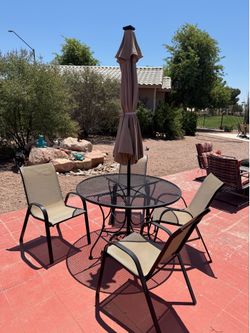 wrought iron patio set with lighted umbrella