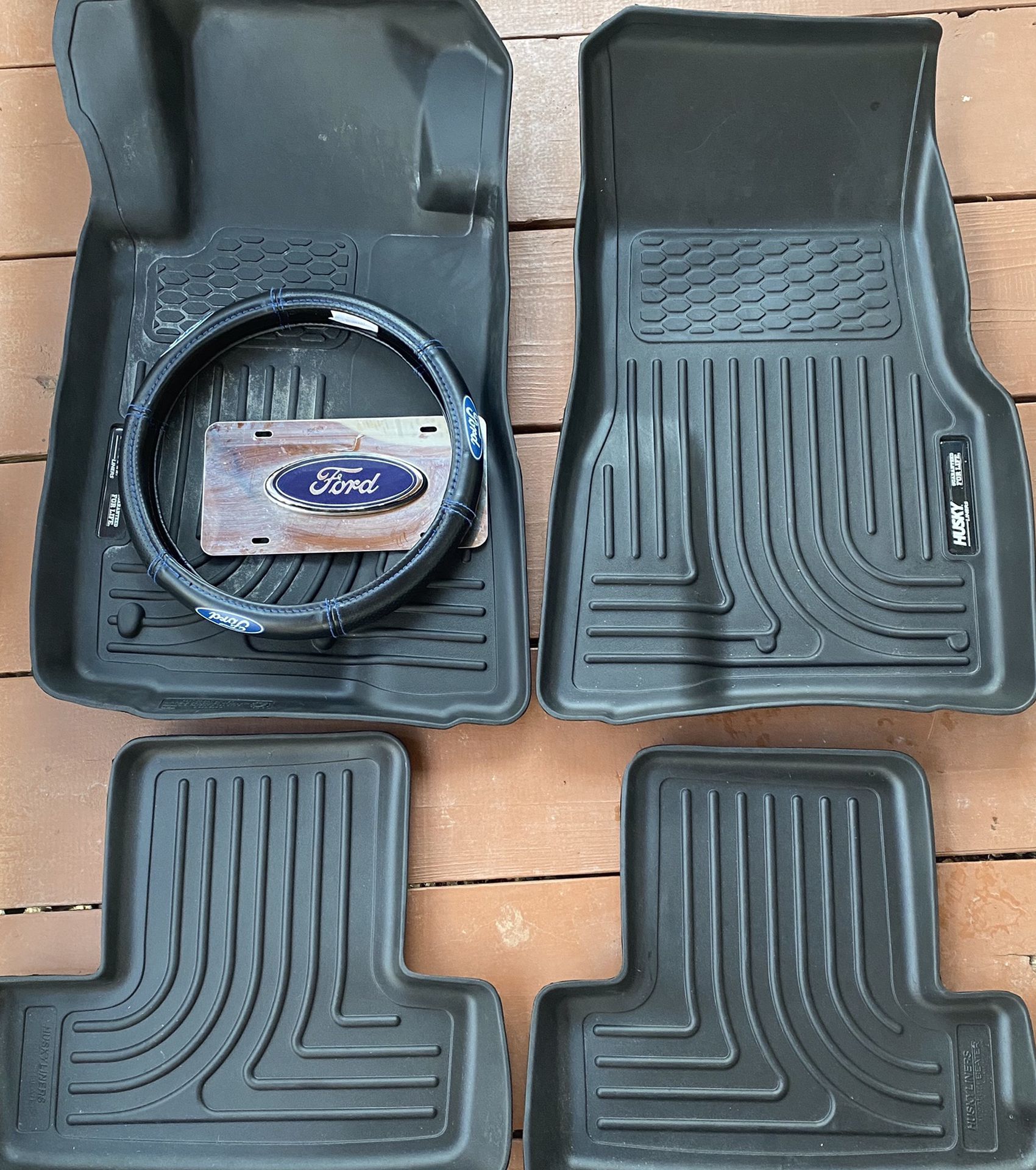 Mustang Floor Mats, A Ford Chrome License Plate, And A Ford Steering Wheel Cover.