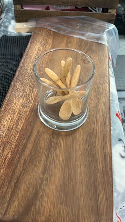 Glass with small wooden spoons