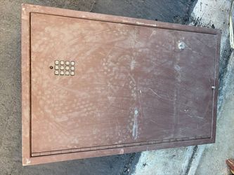 Wall or floor safe with a small built-in electronic keypad and a key