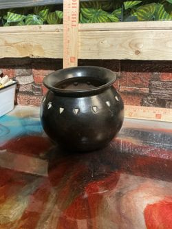 This Black Pottery Vase with White Geometric Accents