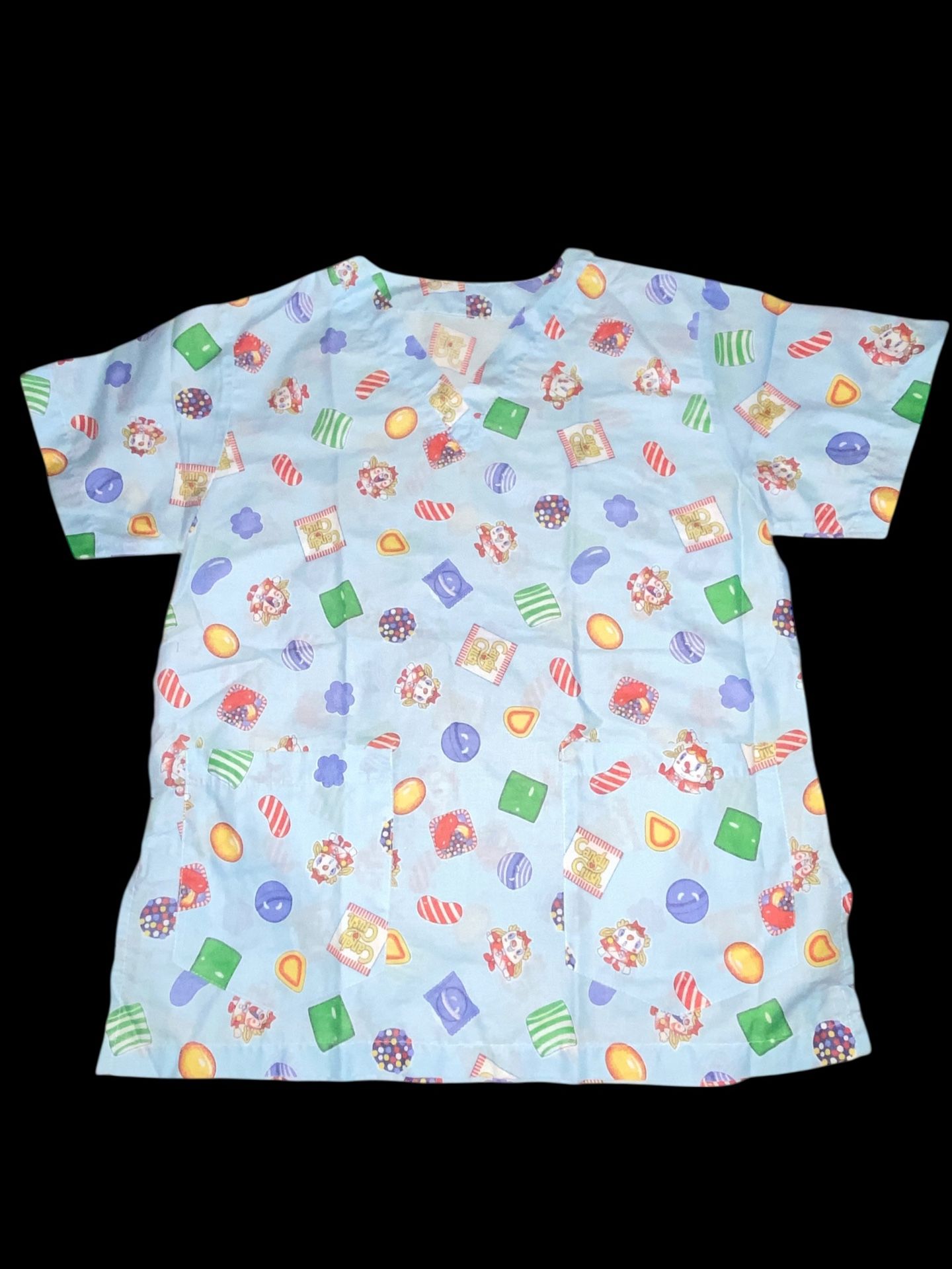 Women’s scrub top with a candy-themed print. 19.5” chest 25.5” length