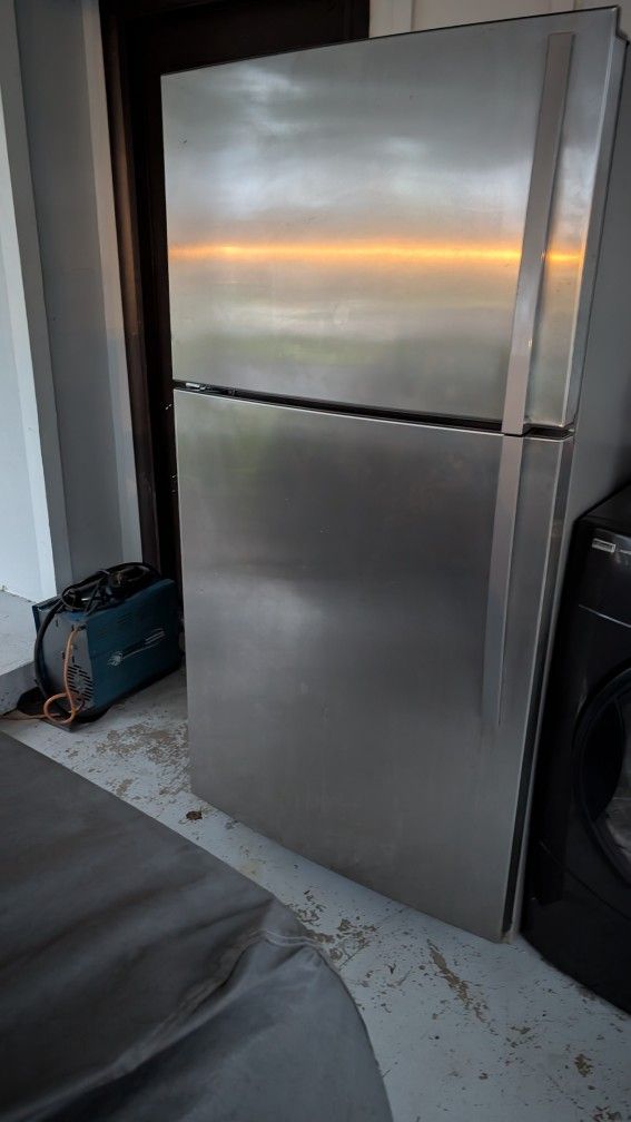 Whirlpool stainless steel refrigerator 33 in by 66 and a half inch tall by 31 in deep