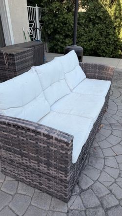 3-seat outdoor patio sofa with cushions.