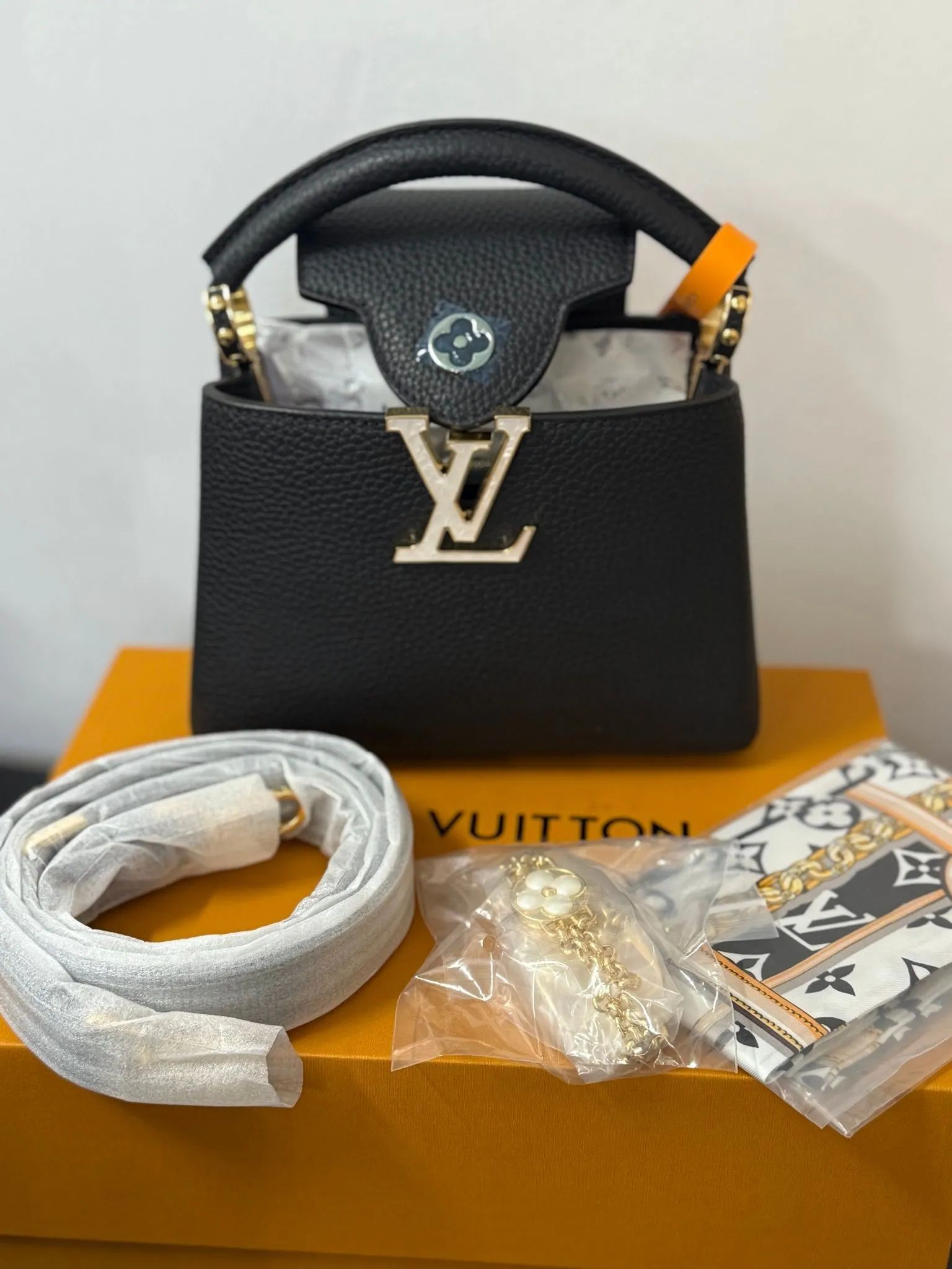 Capucines Mini handbag in black Taurillon leather with gold-color hardware