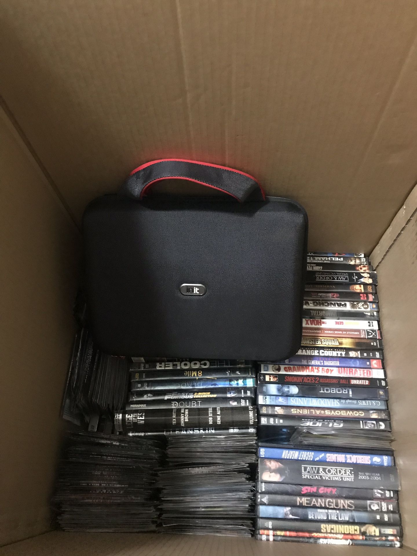 Over 300 Movie DVDs. Approximately 320!!! W/ Portable DVD Player and traveling case.