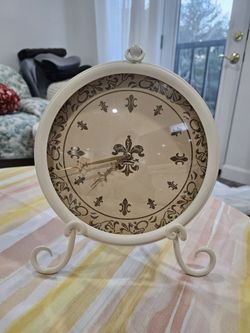 Very pretty, barely used clock with stand.