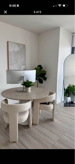 Round pedestal table with two linen chairs