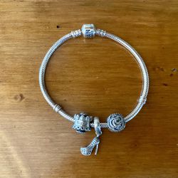 Pandora sterling silver bracelet with three charms size 7.5”