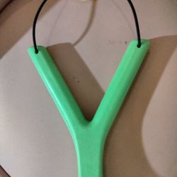 It Is A Green And Yellow Slingshot And It Is Fun To Have Water Balloon Fights