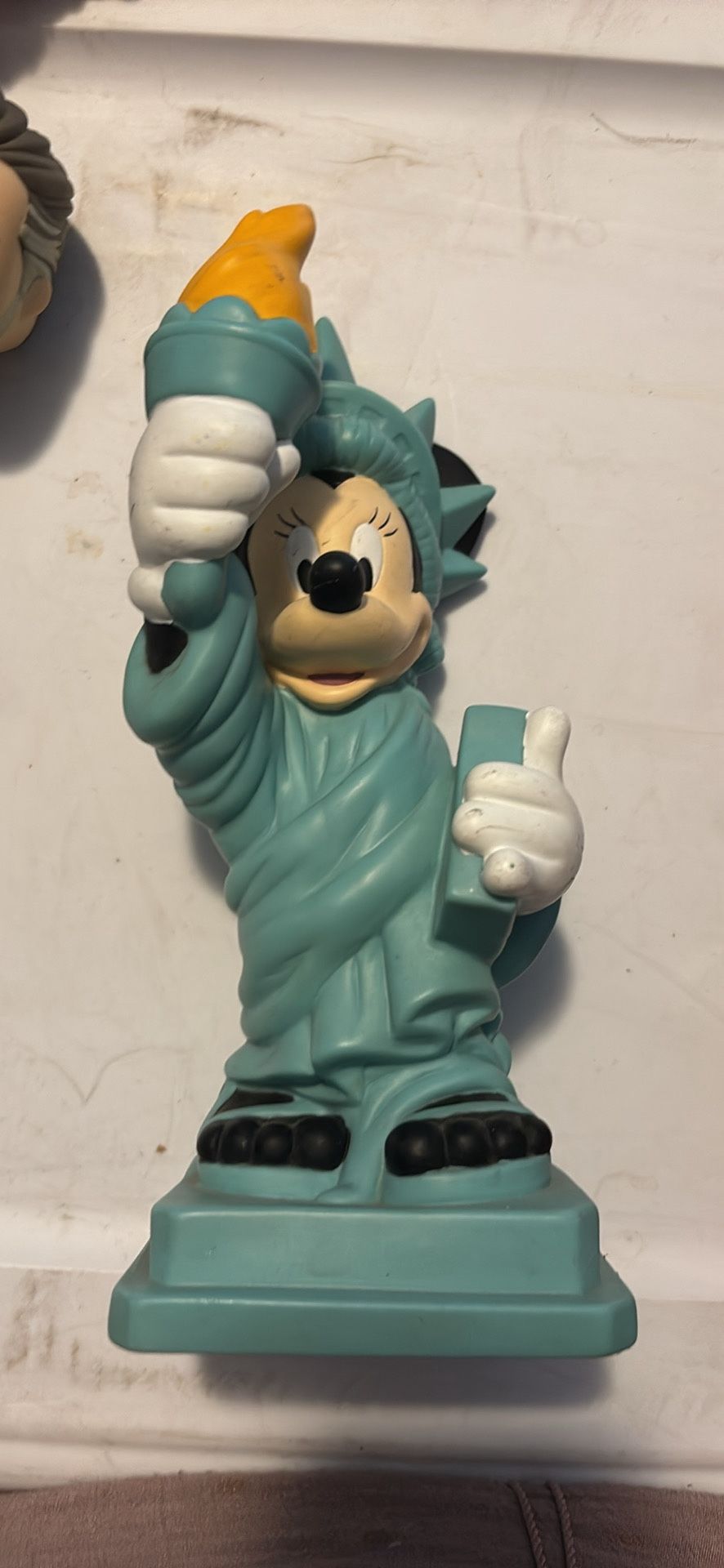 This is a Disney Minnie Mouse Statue of Liberty coin bank or figurine