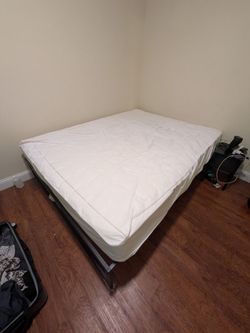 Queen mattress and black metal frame